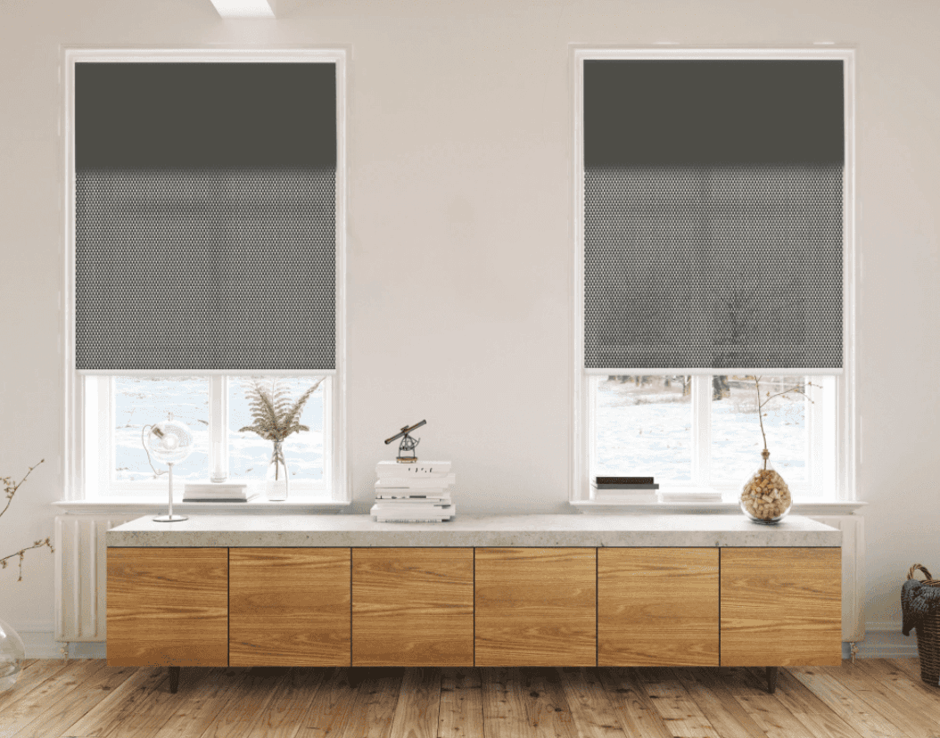 Two windows with modern, gray double roller shades.