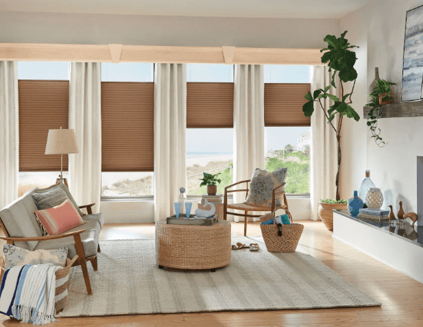Pleasant living room with brown cellular shades and white curtains.