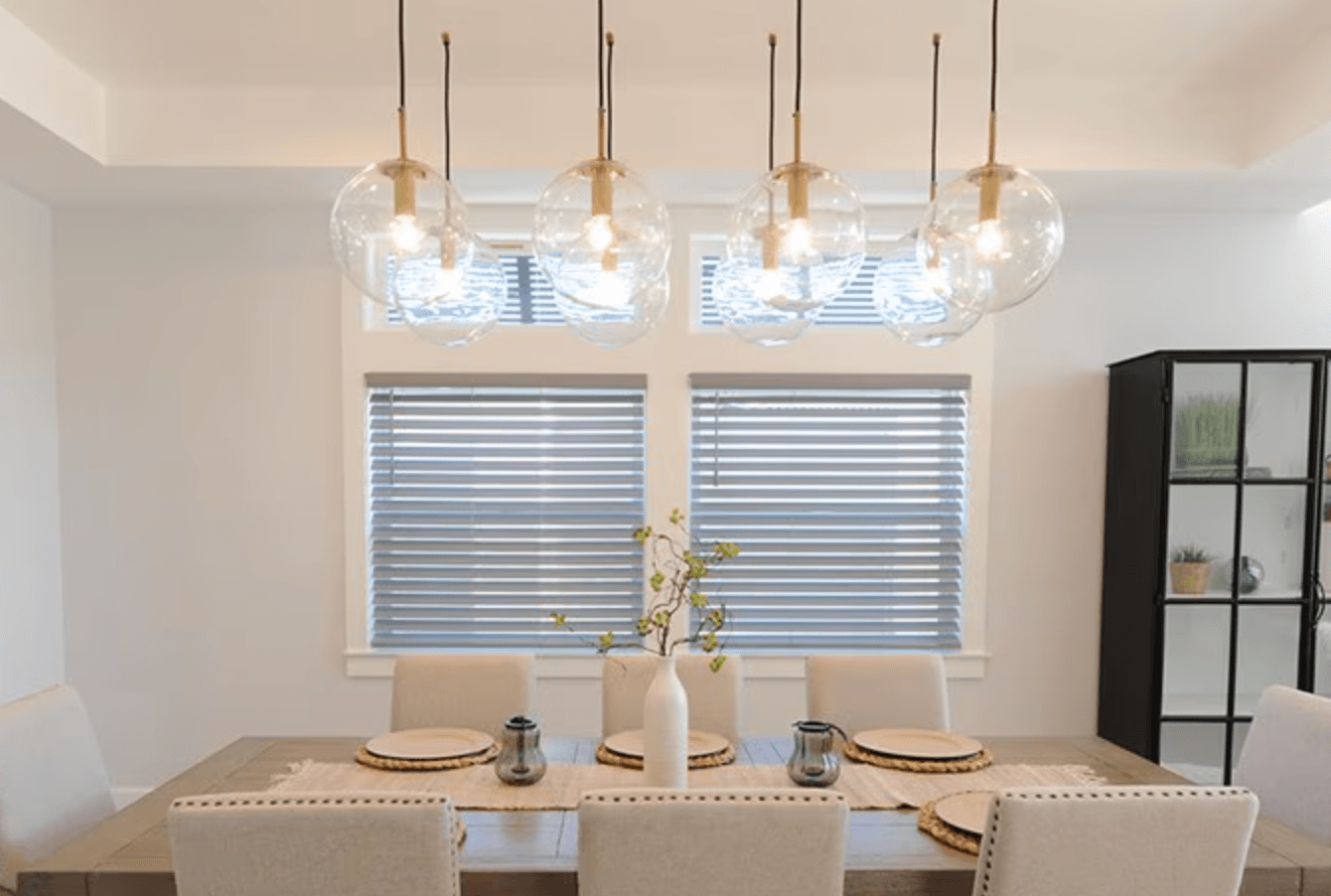 Modern dining room with gray faux wood blinds on windows.